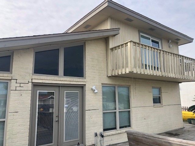 a white house with a balcony and lots of windows | Corpus Christi, TX | GT Roofing