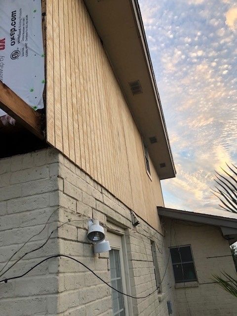 a brick building with a sign on the side that says grip.com | Corpus Christi, TX | GT Roofing