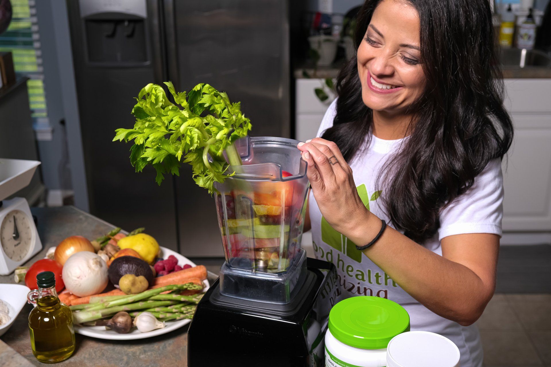 Dani is making a smoothie with vegetables in a blender.