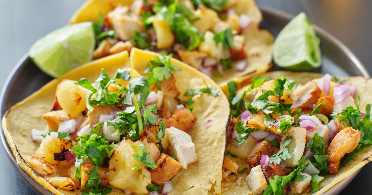 A close up of a plate of tacos on a table.