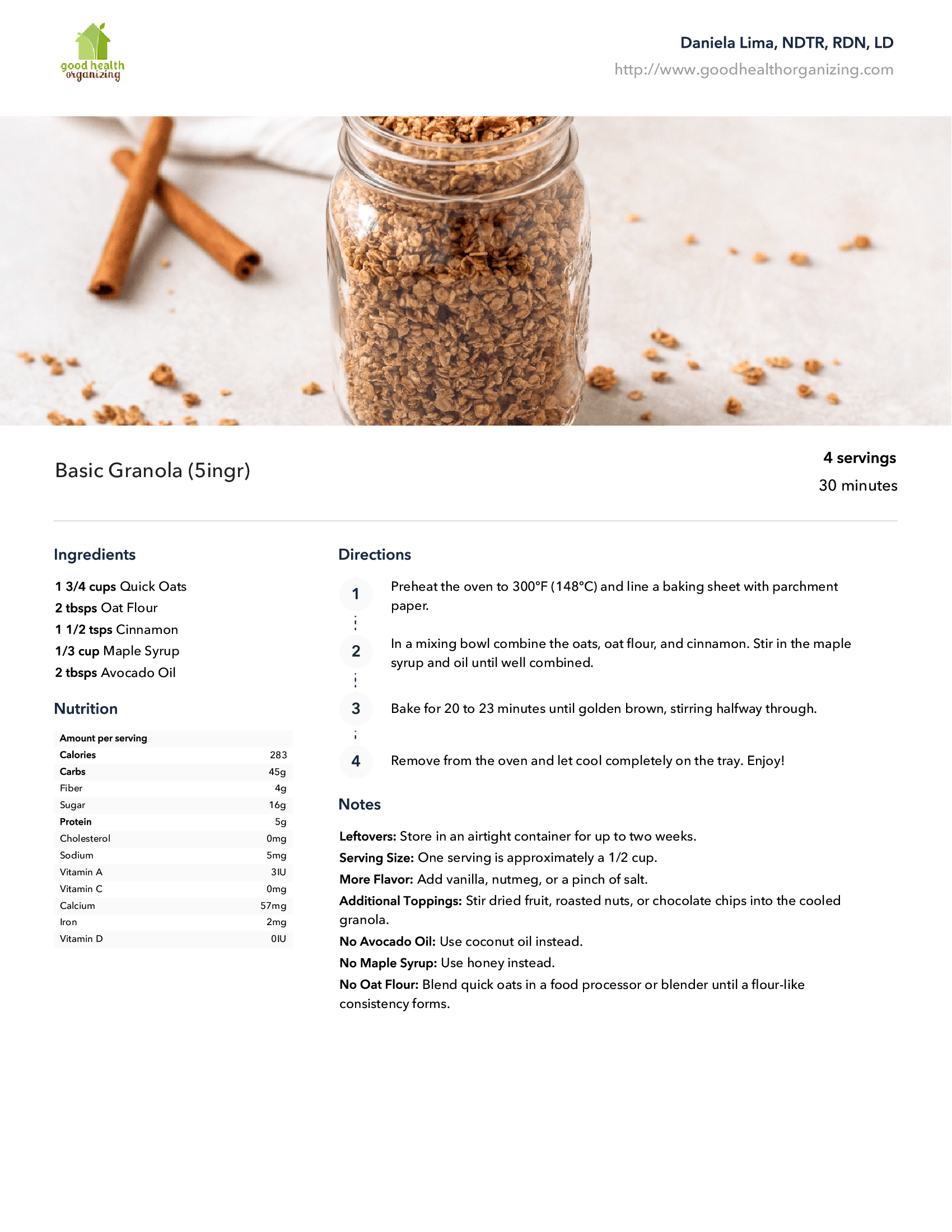 A jar of granola is sitting on a table next to cinnamon sticks.