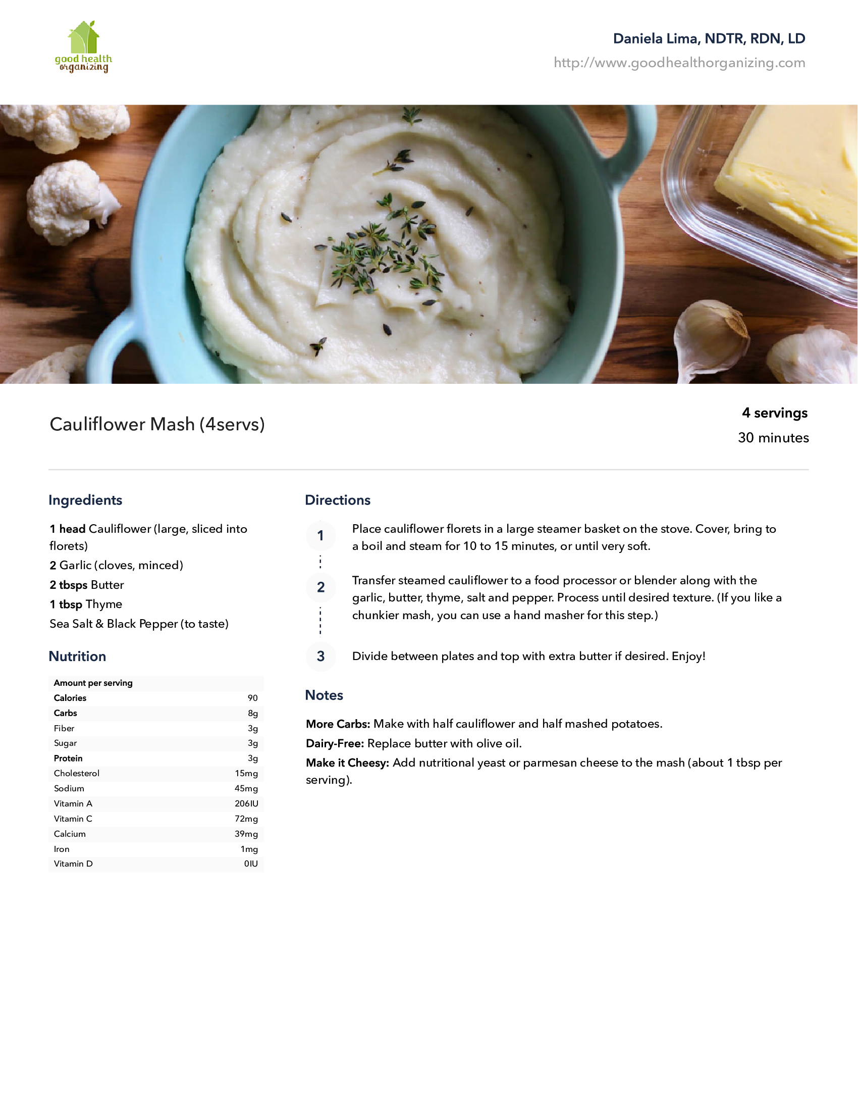 A bowl of mashed potatoes with butter and garlic on a wooden table.