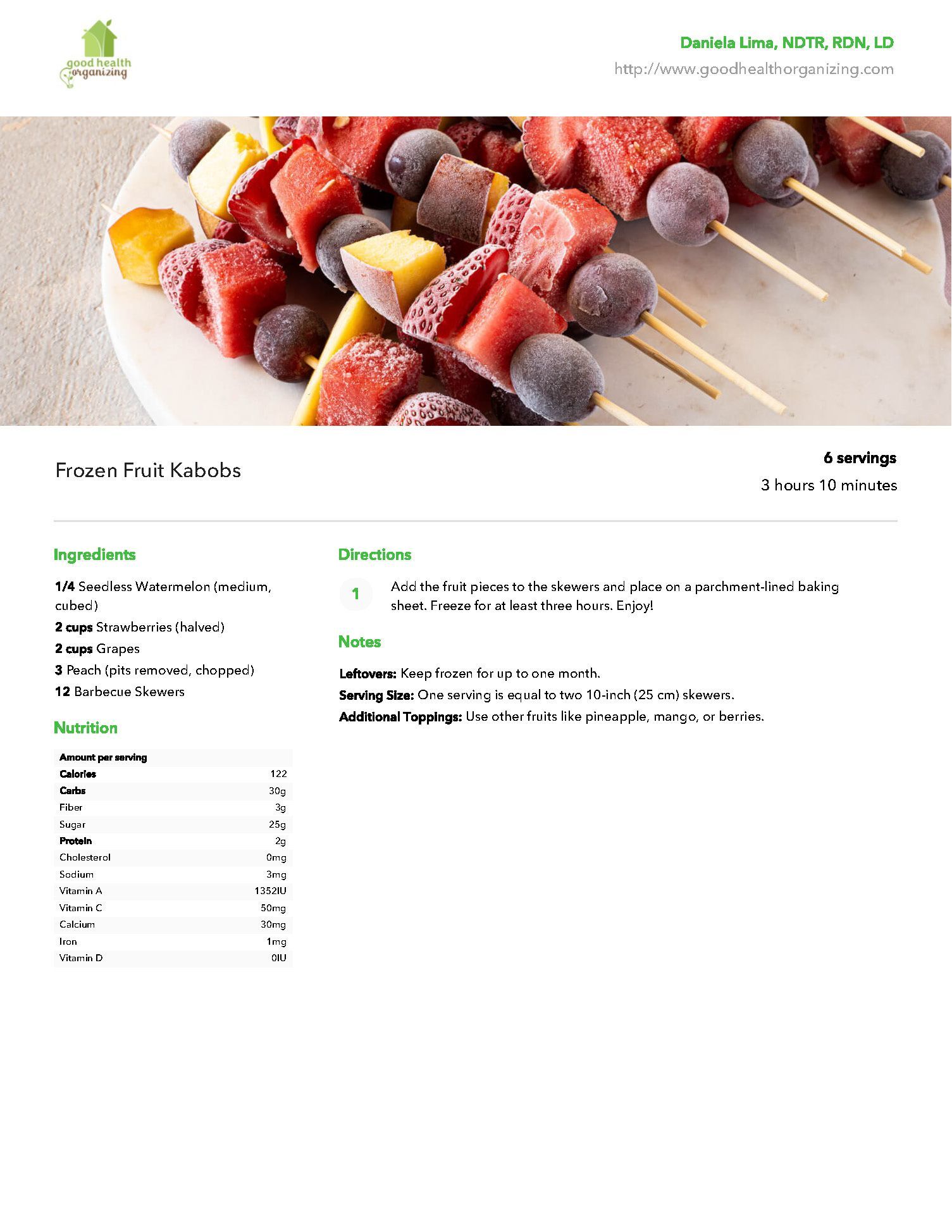 A plate of fruit on skewers on a white plate.