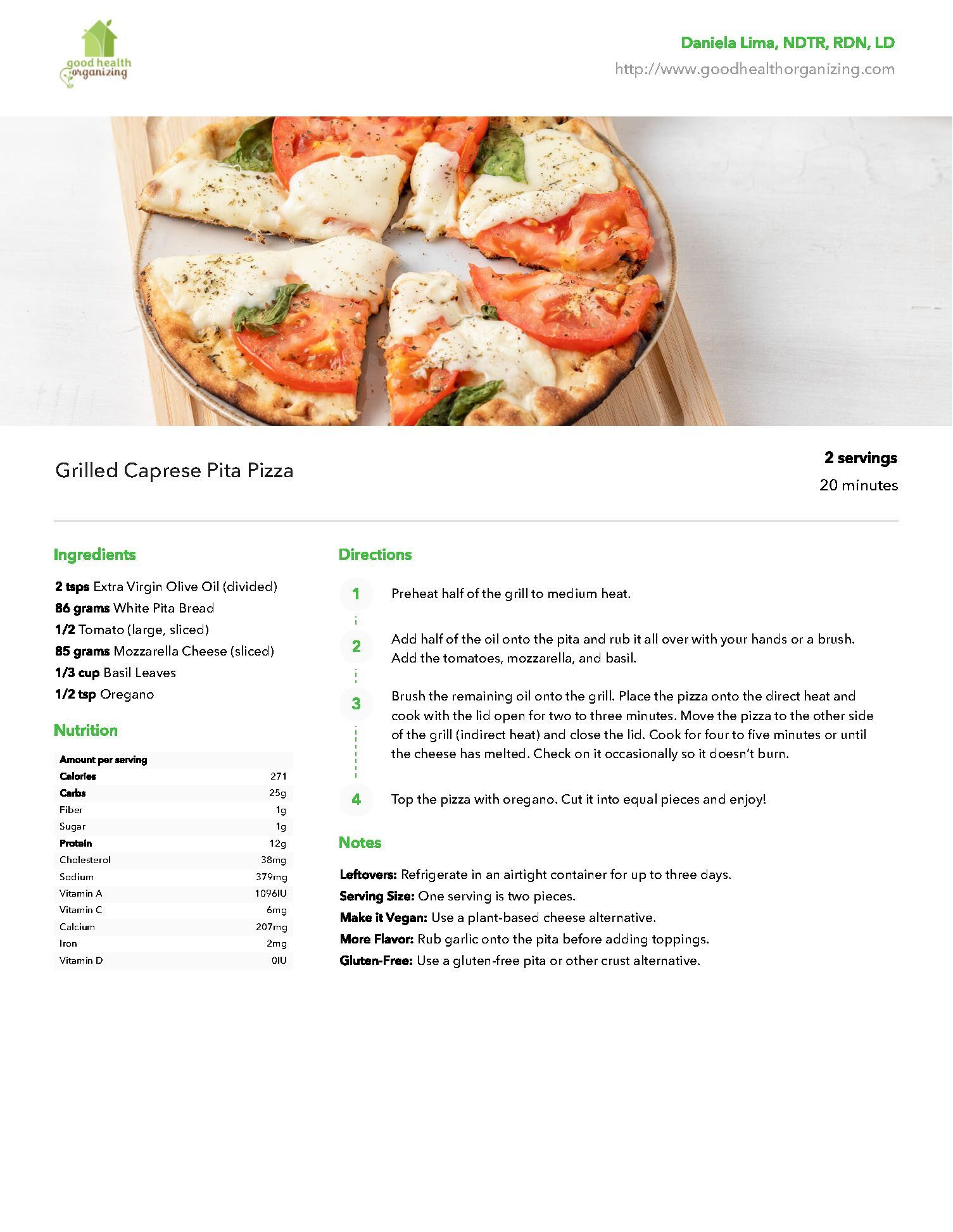 A pizza with tomatoes and cheese is on a plate on a table.