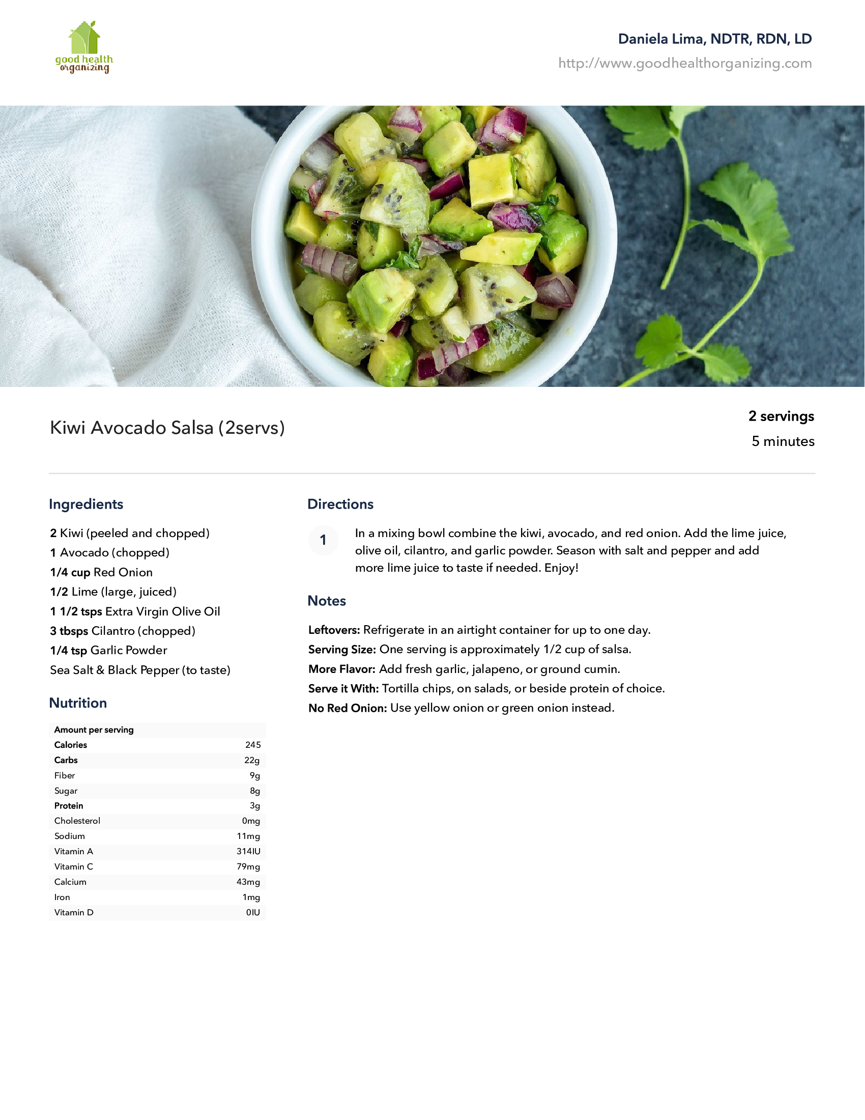 A bowl of avocado salad with kiwi and onions on a table.