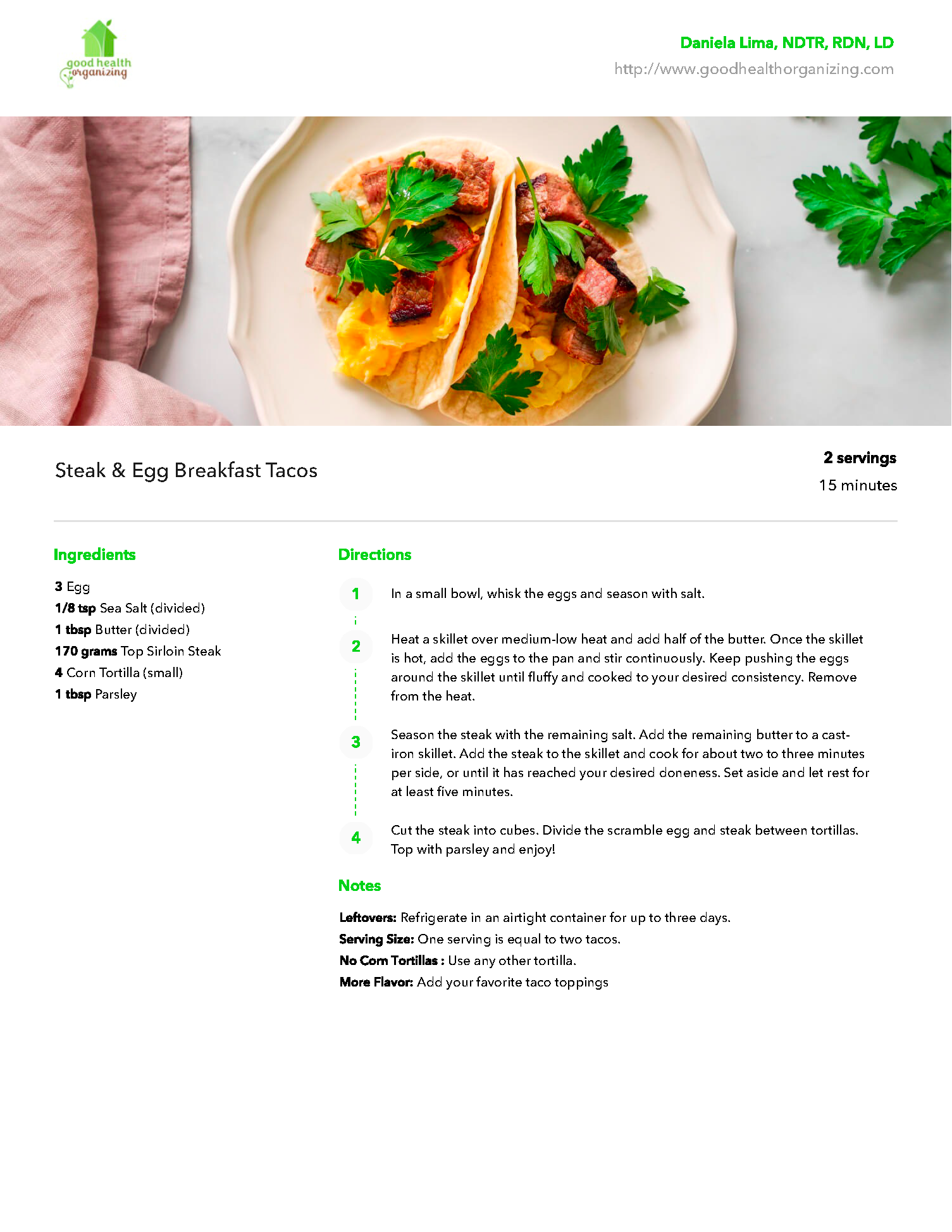 A white plate topped with a taco and vegetables on a table.