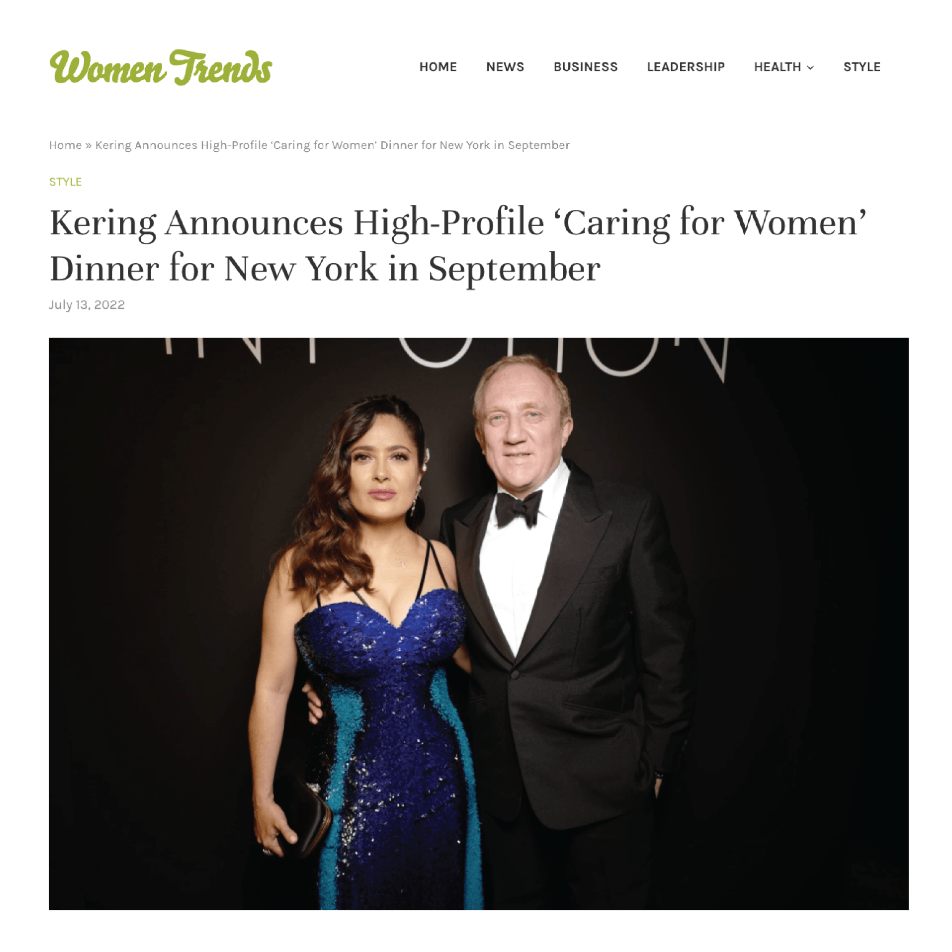 A woman in a blue dress is standing next to a man in a tuxedo.