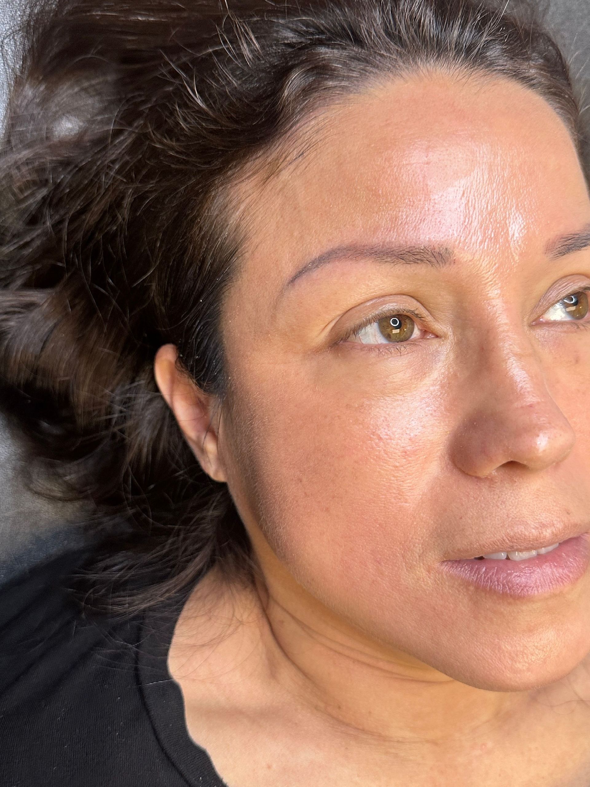 a close up of a woman 's face with a black shirt on .