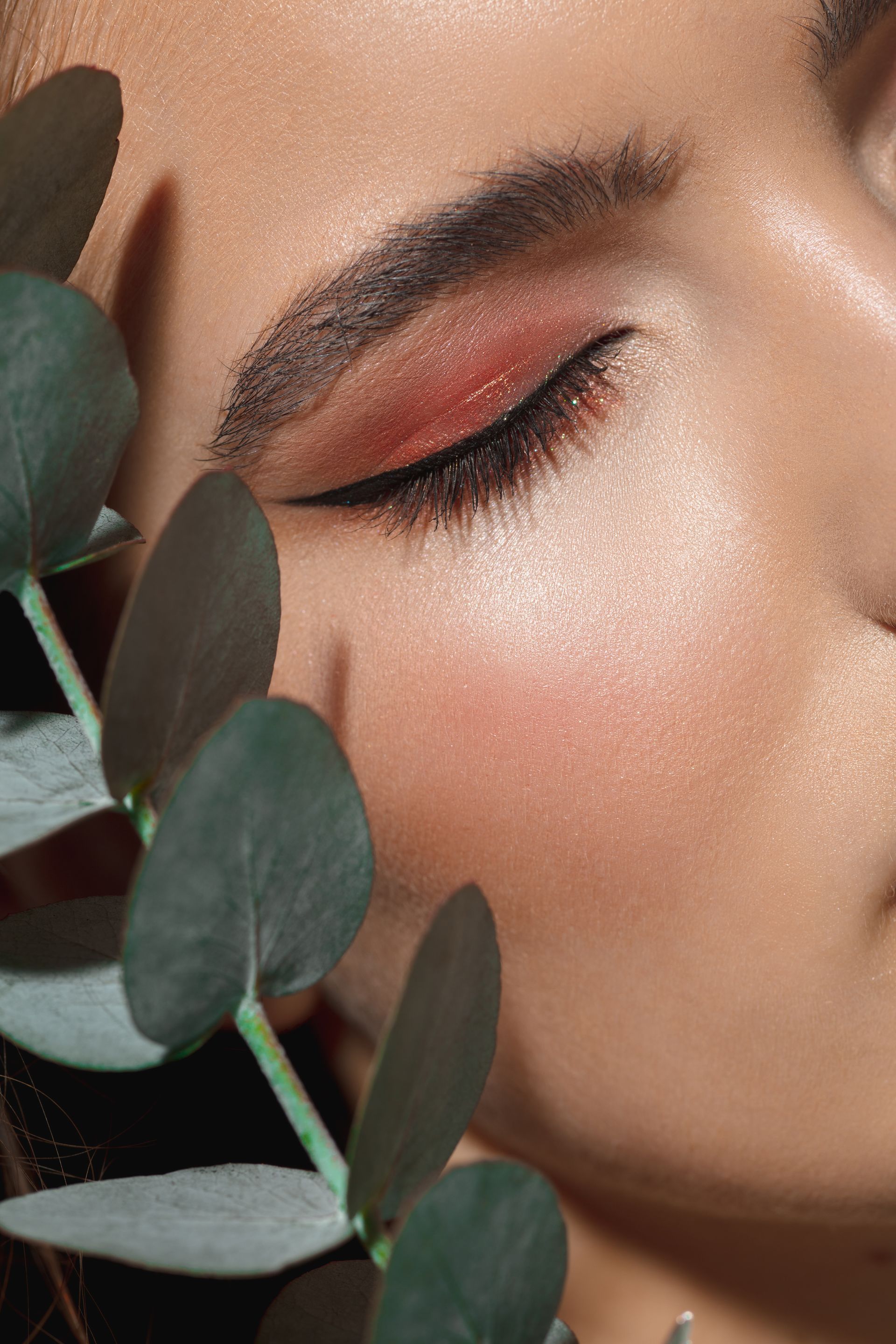 a close up of a woman 's face with her eyes closed
