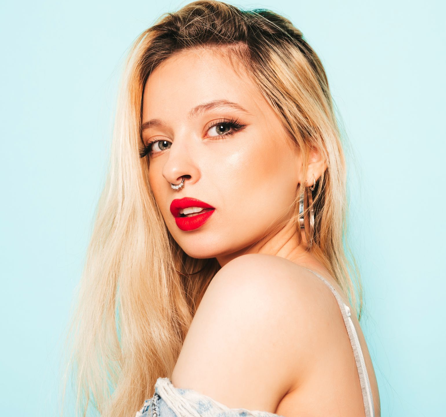 a woman with red lipstick and a nose ring