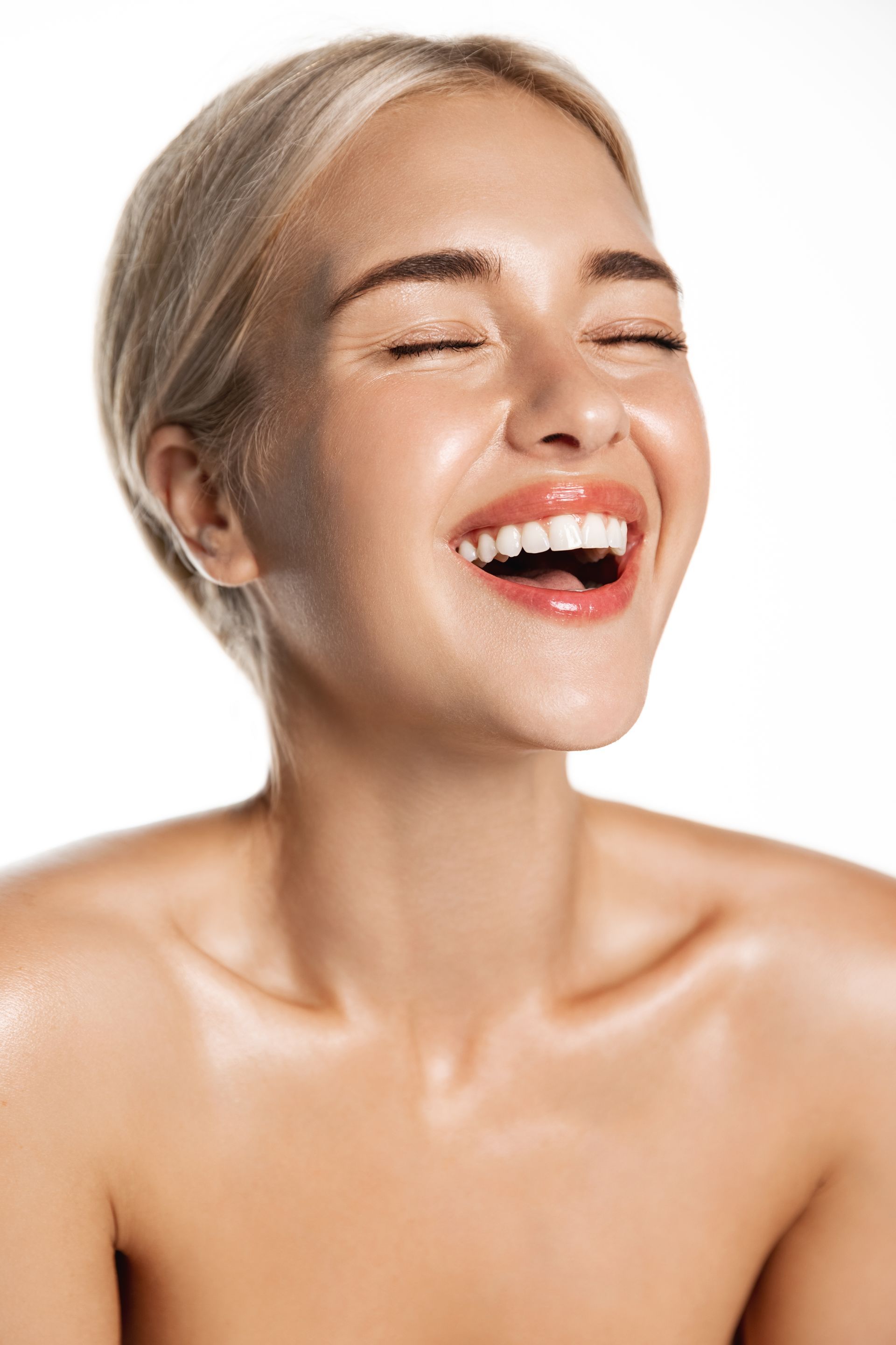 a woman with her hair tied smiles for the camera