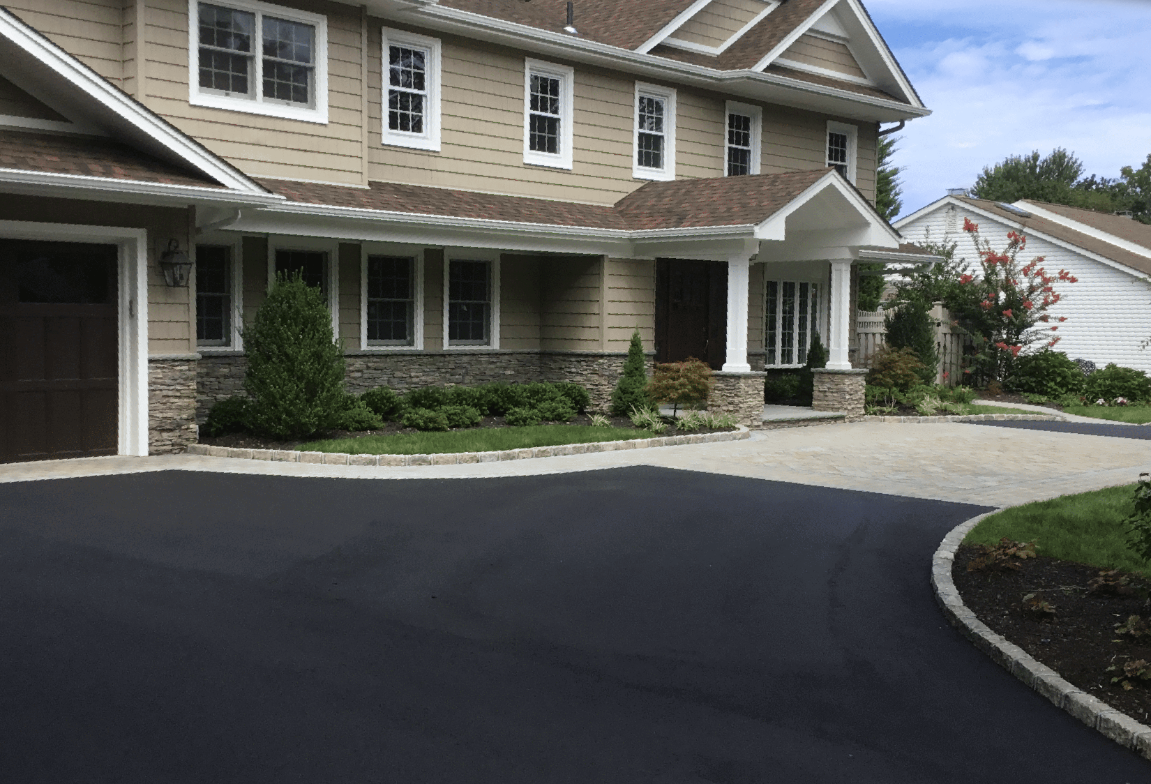A large house with a large driveway in front of it