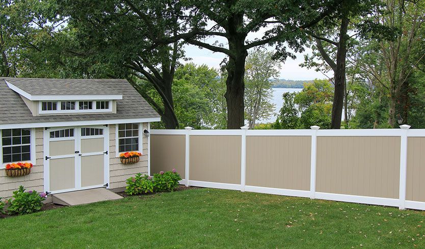A backyard with a shed and a fence surrounding it