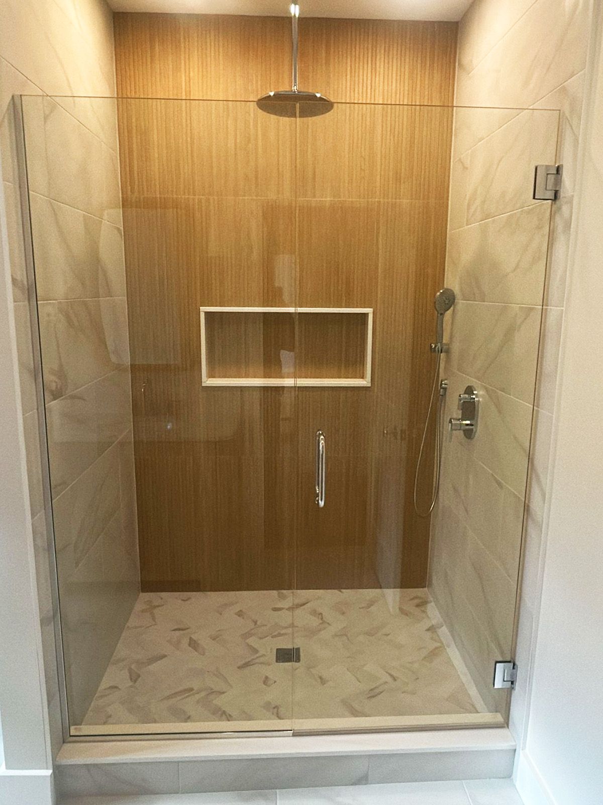 Shower area featuring wall-to-wall glass panels