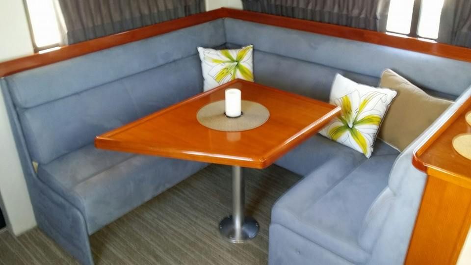 A Wooden Table is Sitting in the Middle of a Couch — Custom Unique Trimming in Mackay, QLD