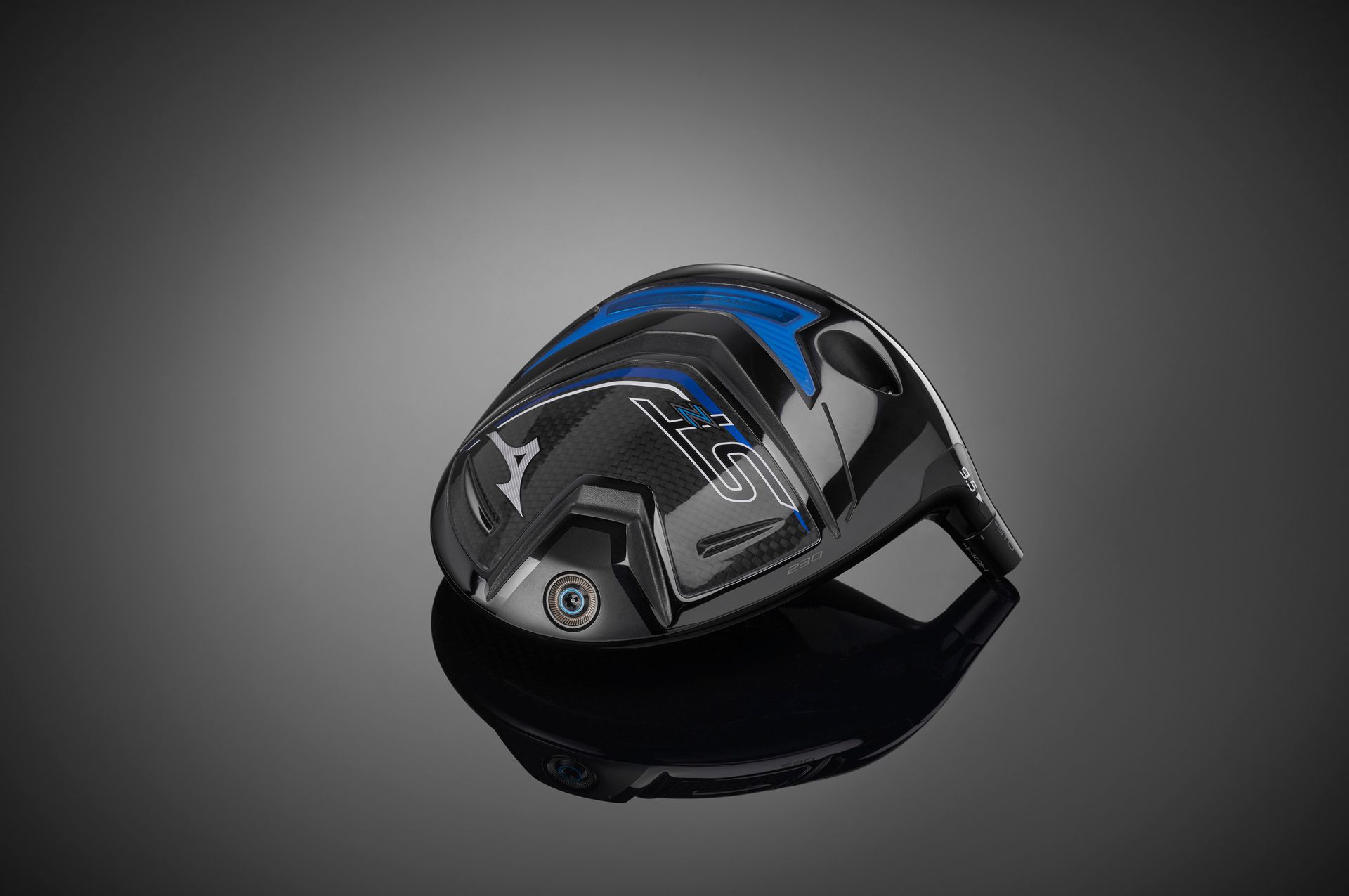 A black and blue golf club head is sitting on a black surface.