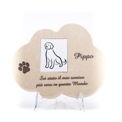 Monumento commemorativo in pietra a forma di nuvola per un animale domestico di nome Pippo, con l'illustrazione di un cane, l'impronta di una zampa e una scritta in italiano.