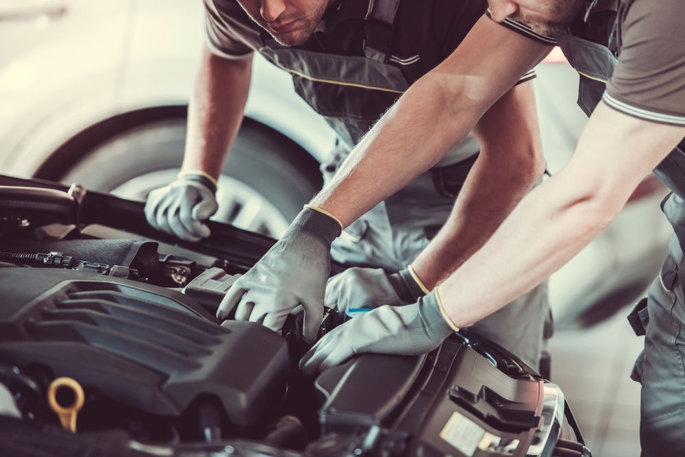 Two Mechanics Are Working on a Car Engine in a Garage — Port Service Centre In Port Macquarie, NSW