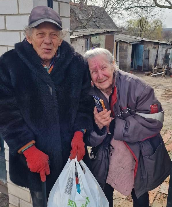 Hands holding a loaf of fresh bread