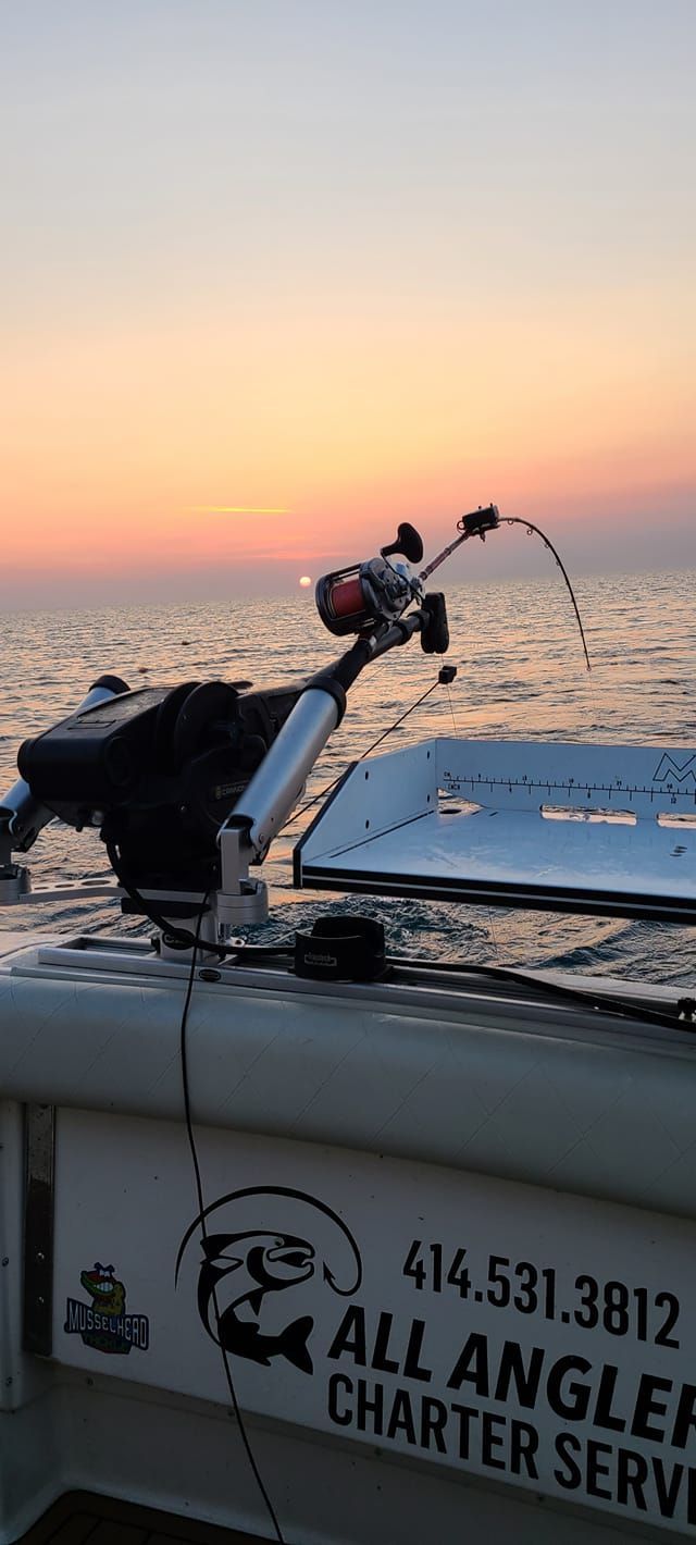 A fishing rod is sitting on the side of a boat.