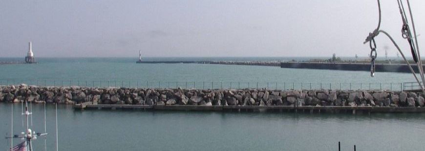 A large body of water with a dock in the foreground