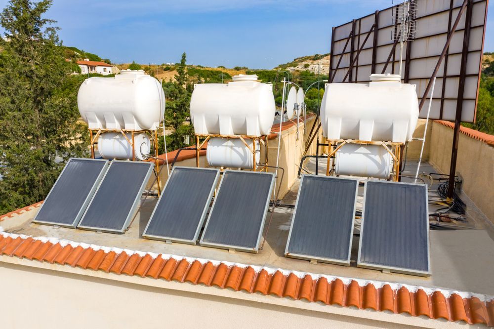 Solar panels mounted on a brown tiled roof under a partly cloudy blue sky. — 24/7 Hot Water in Gympie, QLD