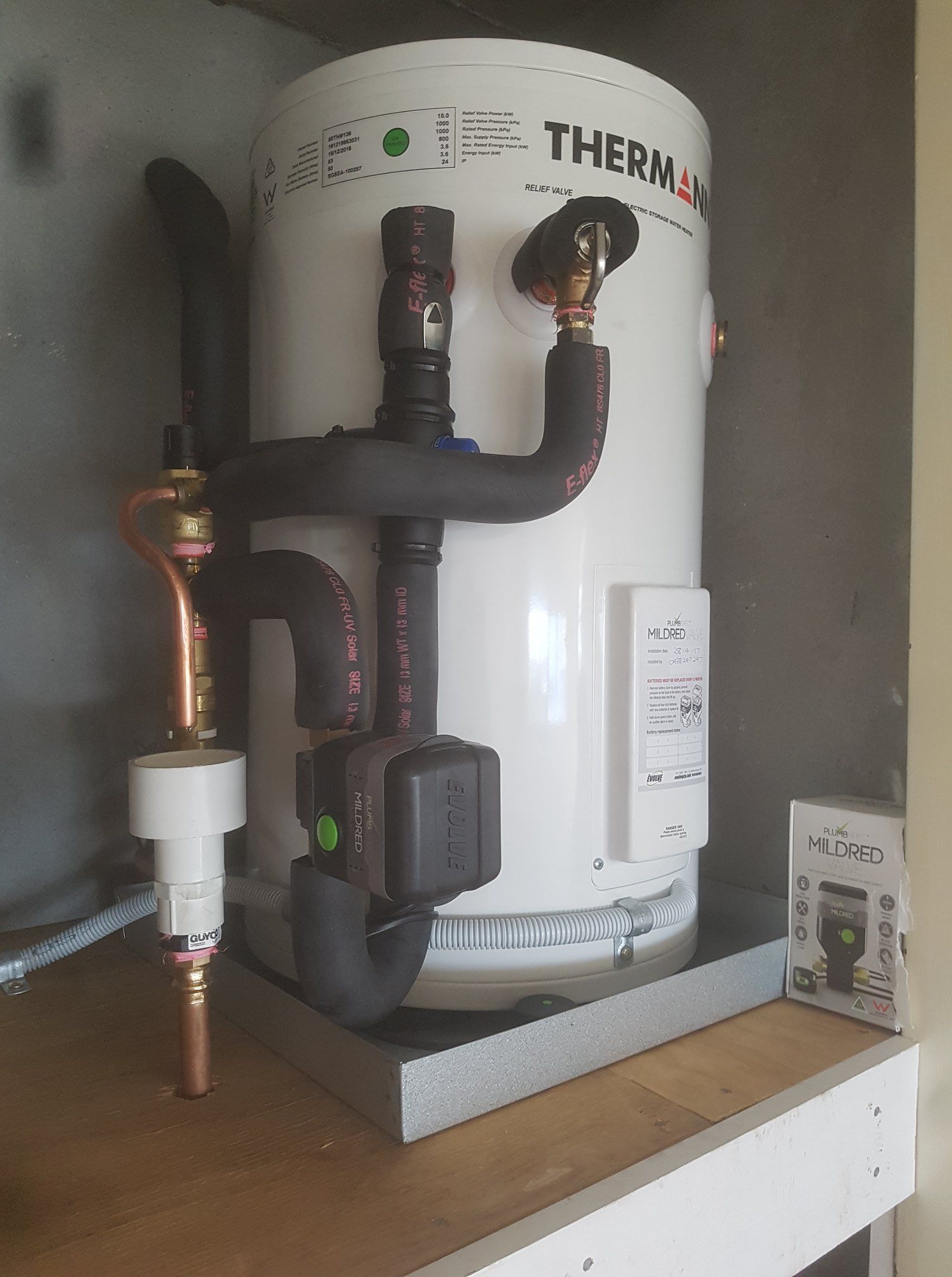 White Hot Water Tank With Copper Piping and Black Insulation in a Cabinet — 24/7 Hot Water in Gympie, QLD