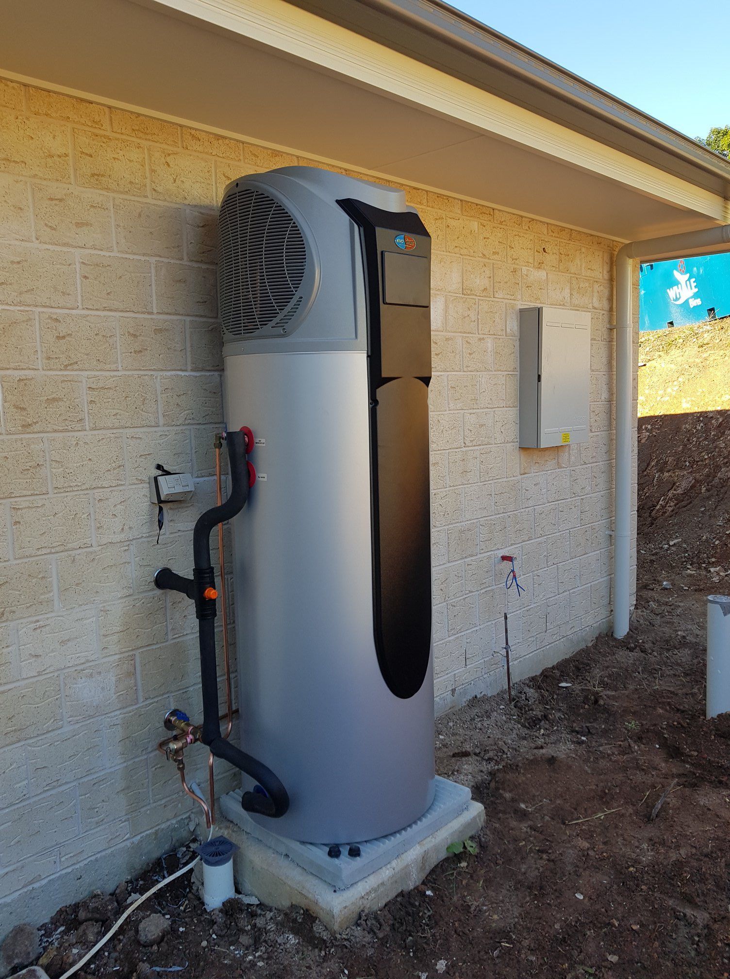 Heat Pump Water Heater Installed Outside a Building on a Concrete Pad — 24/7 Hot Water in Maroochydore, QLD
