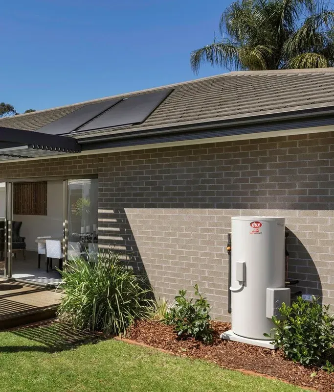 Solar Panels on a Roof, Brick House Exterior, a Water Heater, and a Small Garden — 24/7 Hot Water in Valdora, QLD