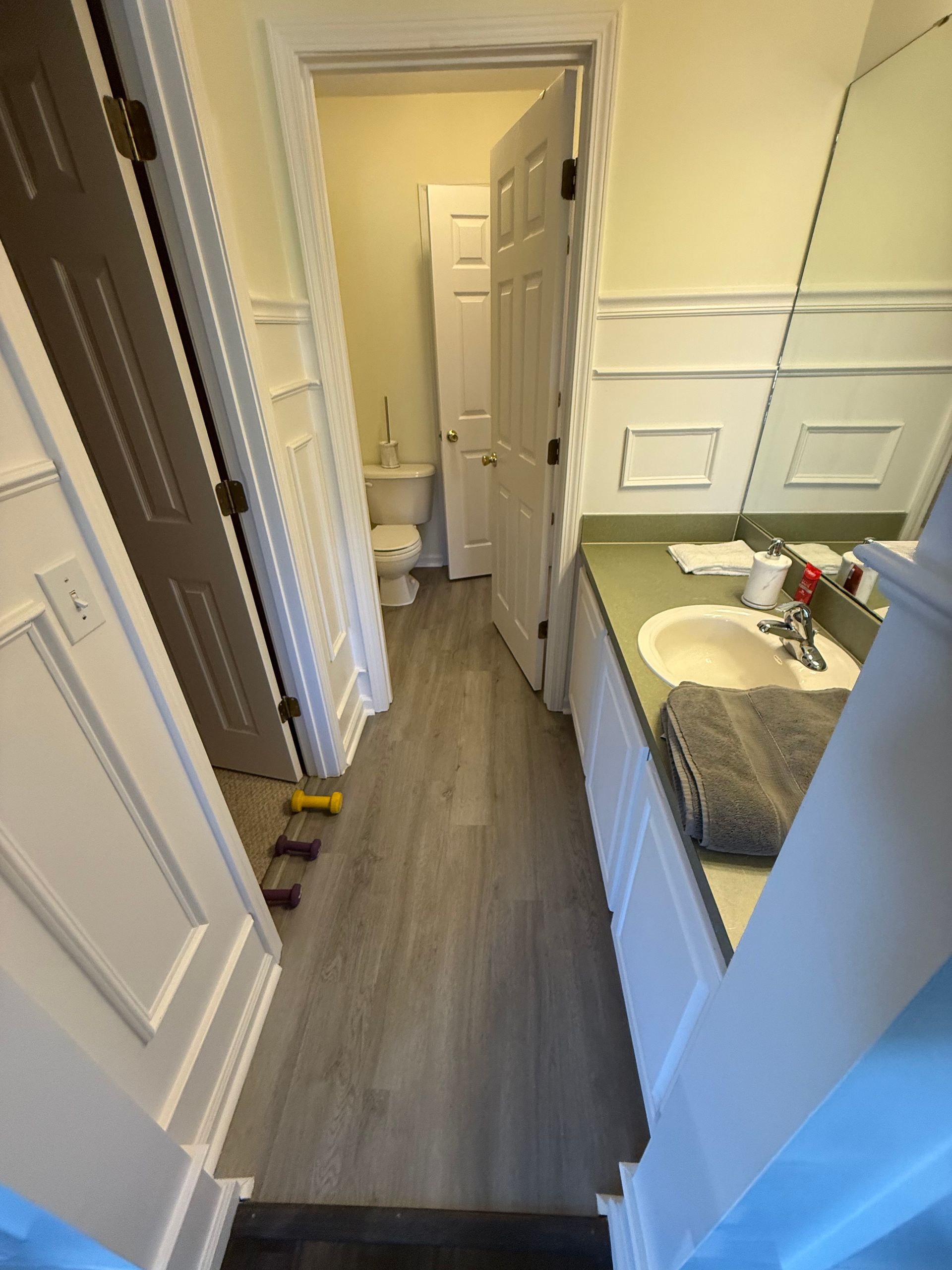 A professional installing a glass shower door in a modern bathroom. A professional installing a glass shower door in a modern bathroom.