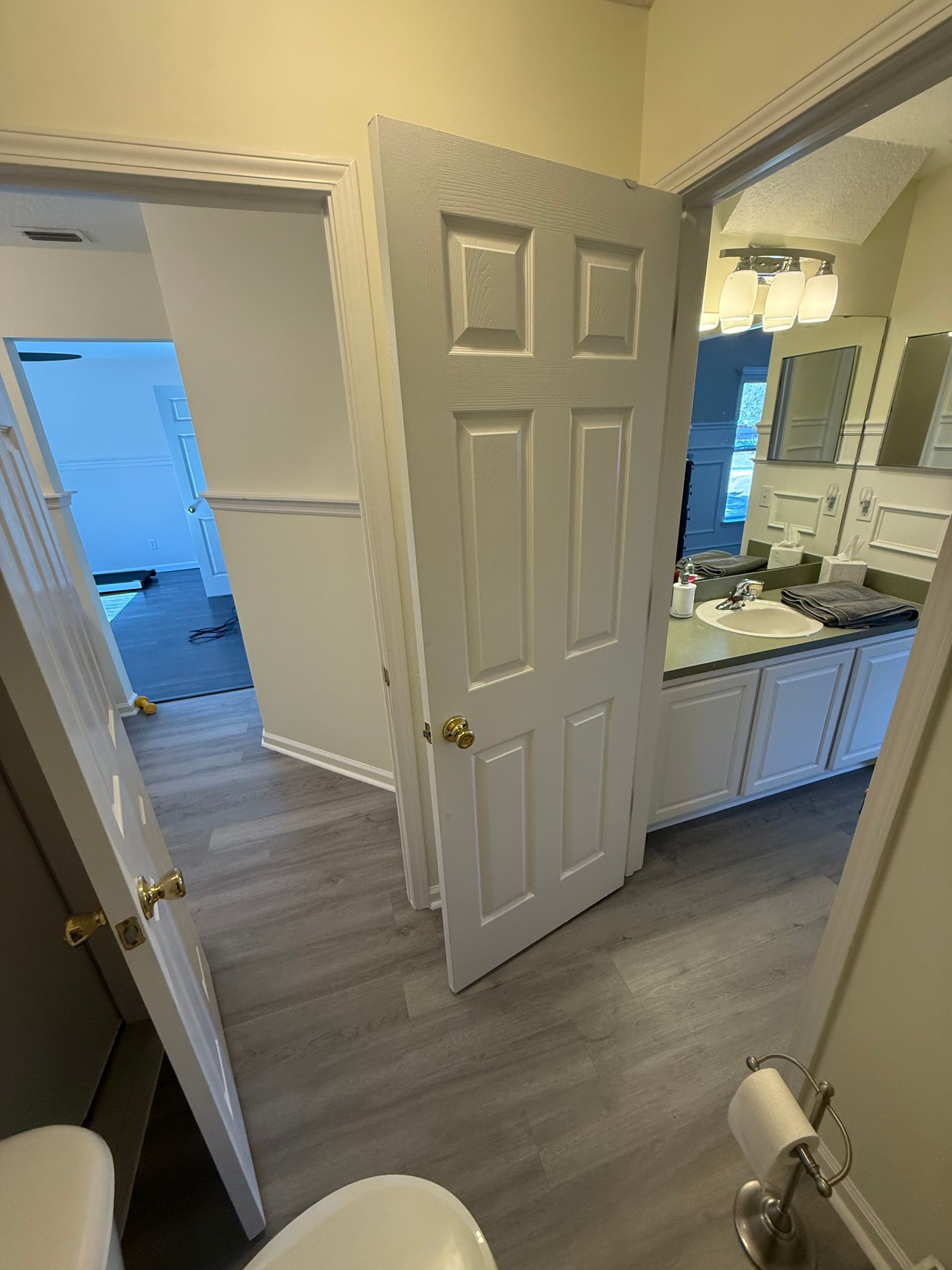 A bathroom with a tiled walk-in shower, a soaking tub, and a wooden vanity cabinet next to a window with frosted glass. A bathroom with a tiled walk-in shower, a soaking tub, and a wooden vanity cabinet next to a window with frosted glass.