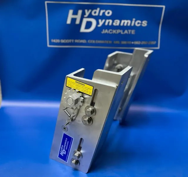 Silver hydraulic jackplate with control knobs, shown on a blue Hydro Dynamics background
