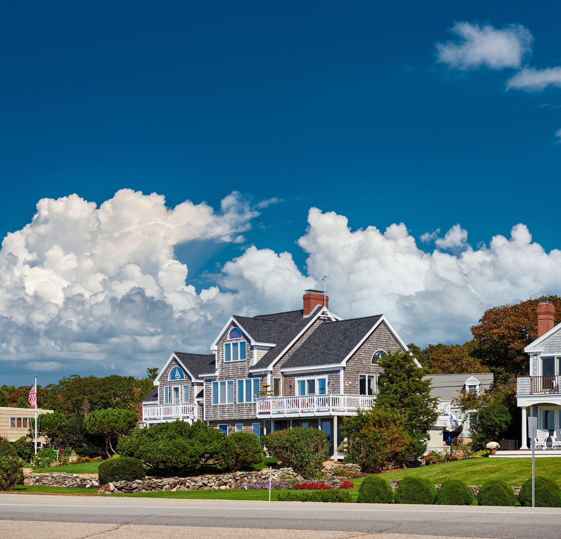 Colorful seaside houses under a bright blue sky with large white clouds