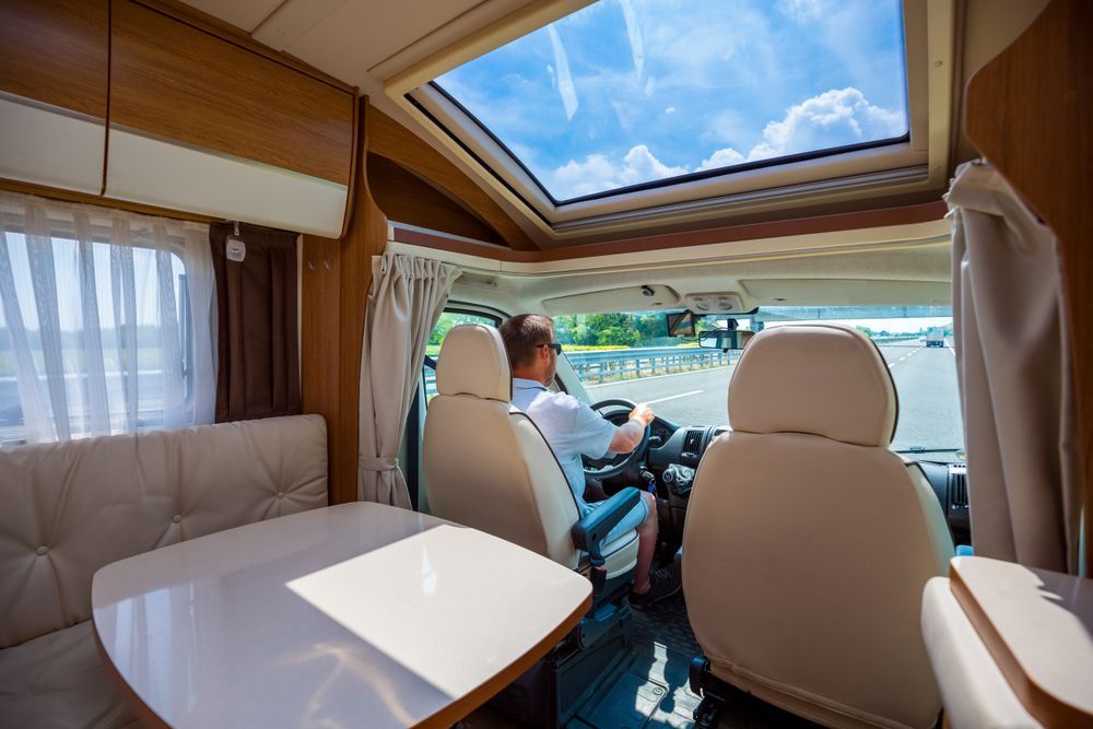 A Man is Driving a Camper Van on a Highway — Furniture & Auto Pride in Port Macquarie, NSW