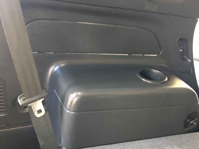 The Back Seat of a Car Has a Cup Holder and a Seat Belt — Furniture & Auto Pride In Port Macquarie, NSW