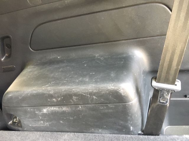 A Black Box is Sitting in the Back of a Car Next to a Seat Belt — Furniture & Auto Pride In Port Macquarie, NSW