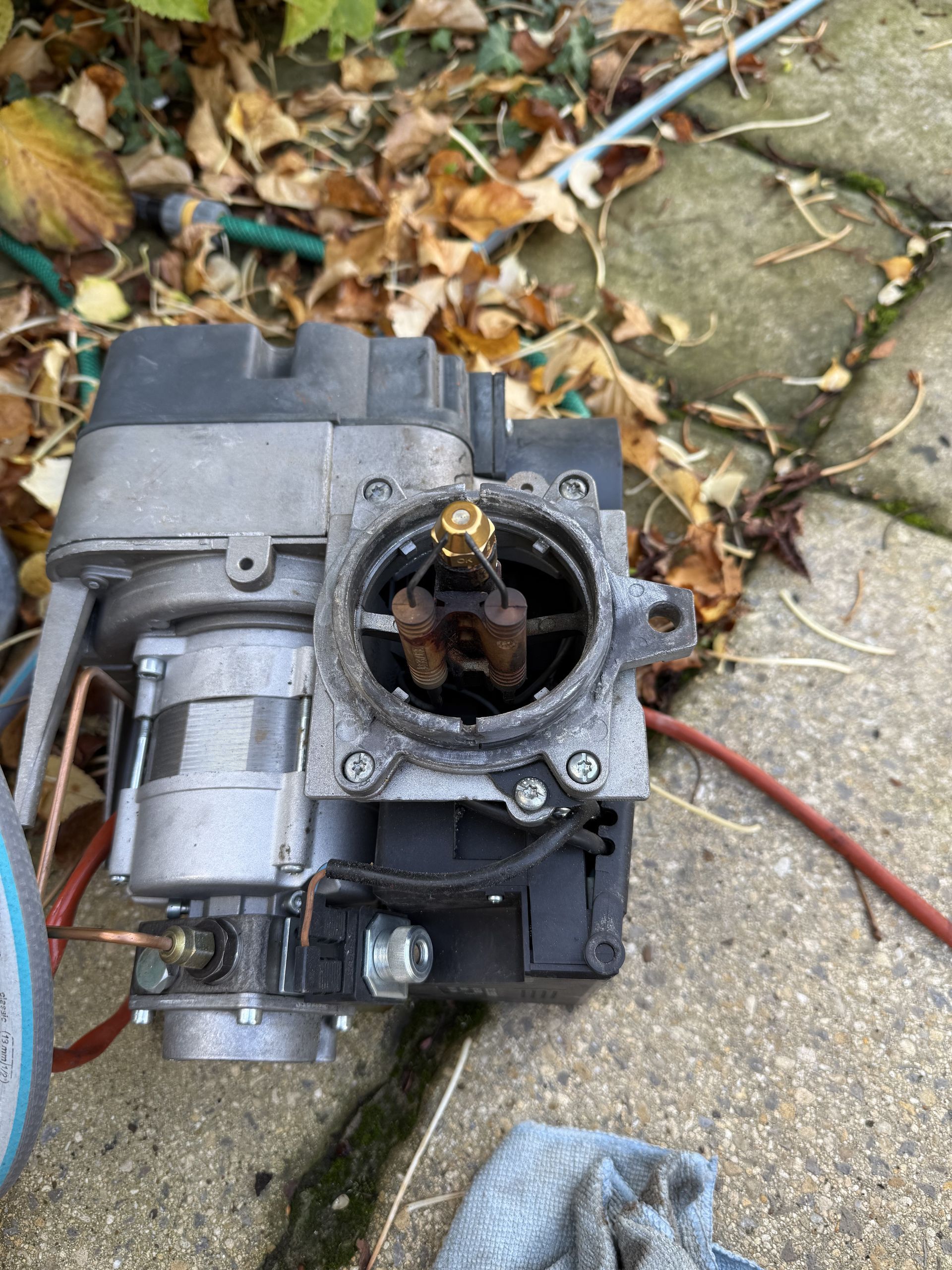 Oil boiler burner being cleaned during routine service