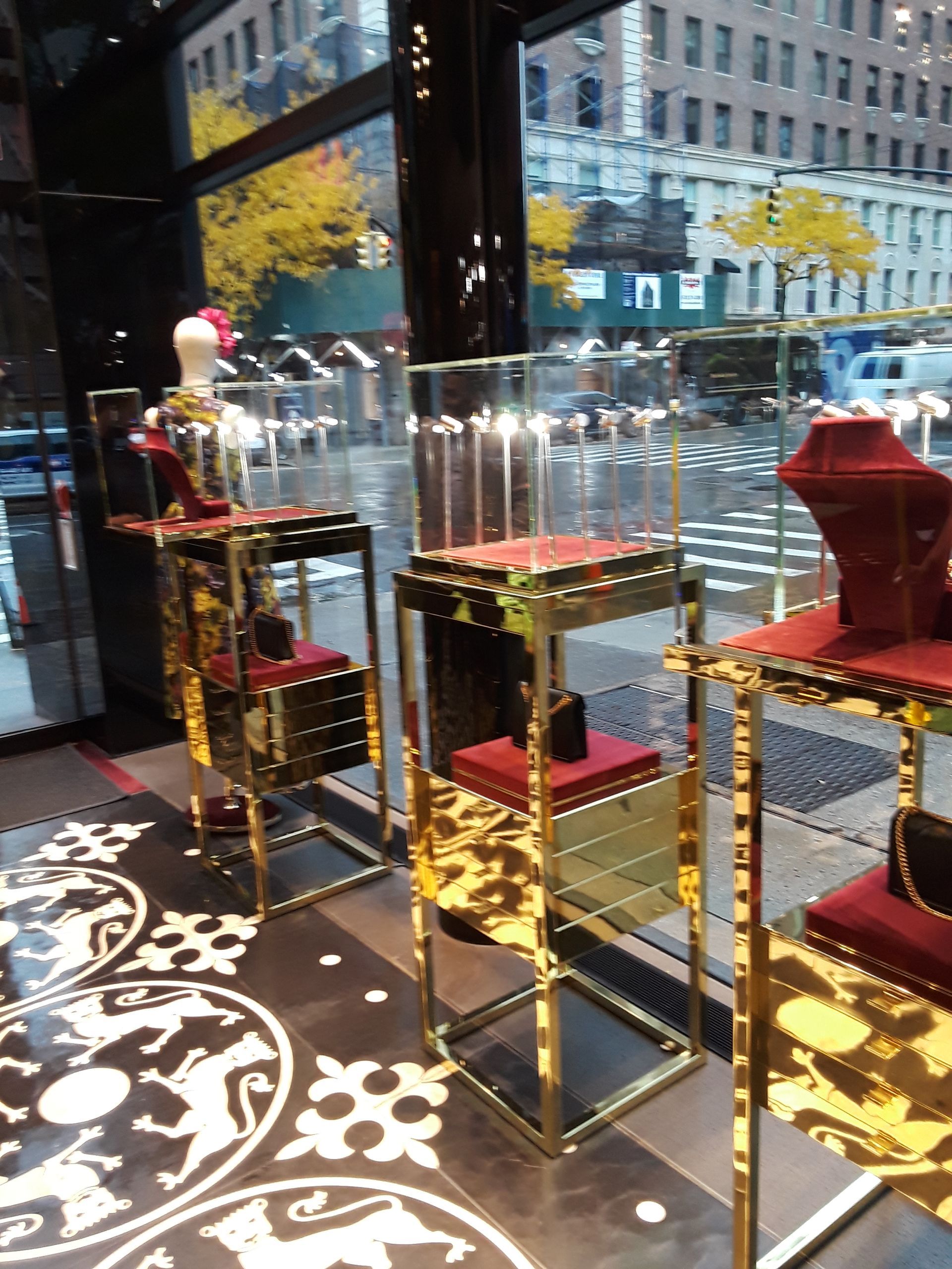 A display of jewelry in a store with a street in the background