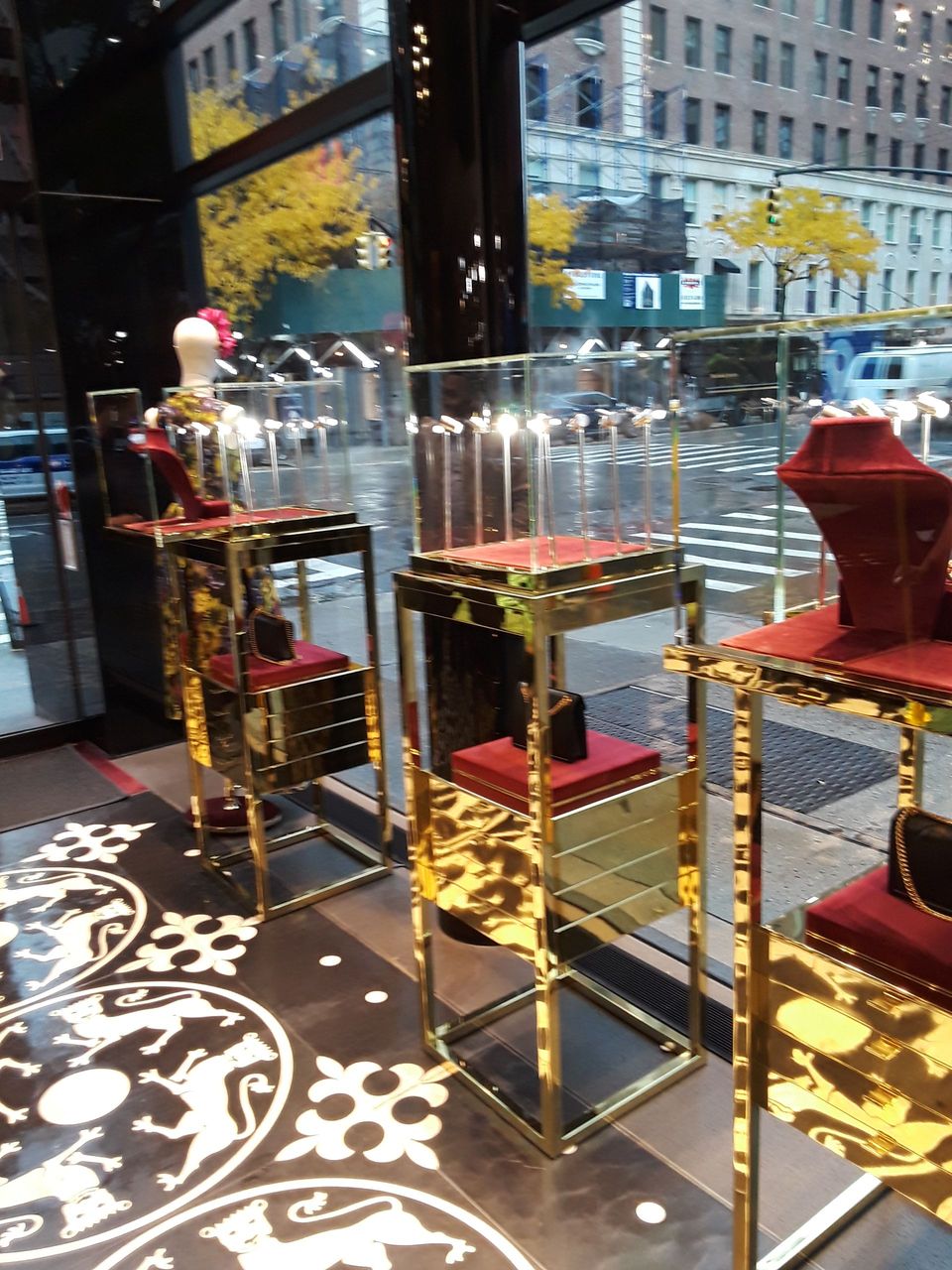 A display of jewelry in a store with a street in the background