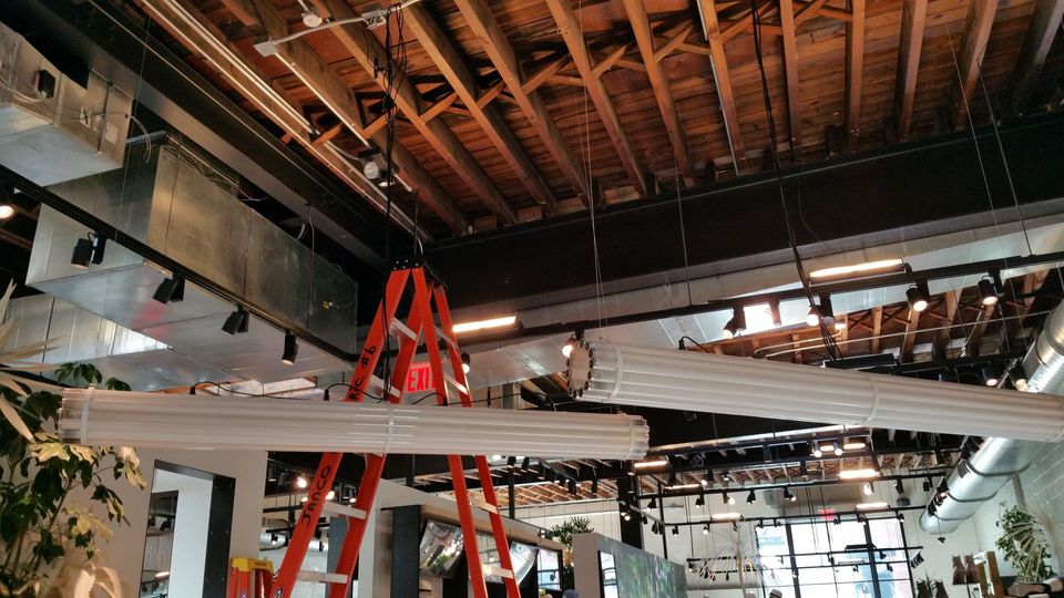 A ladder is hanging from the ceiling of a building.