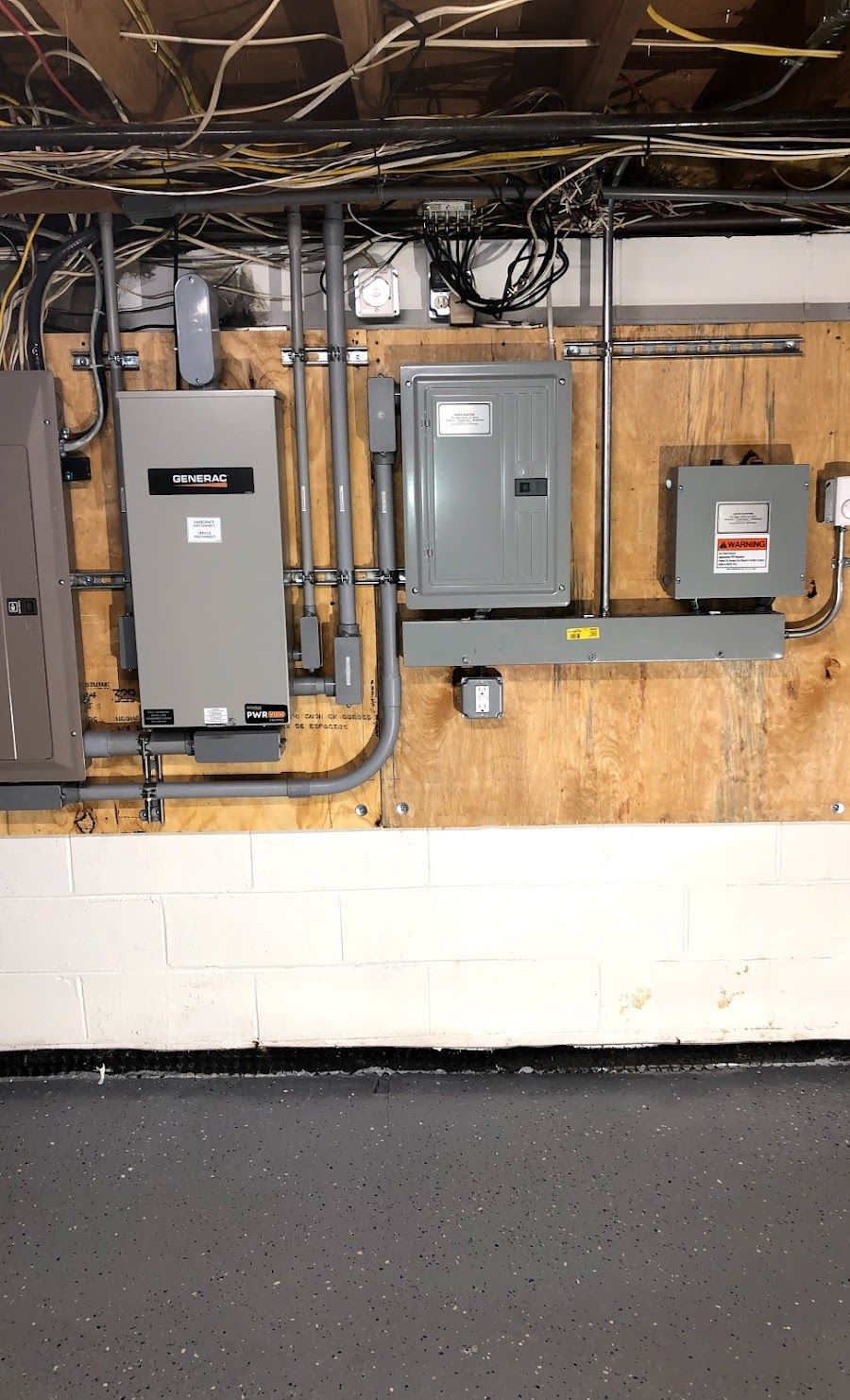 A wall with a lot of electrical equipment on it.