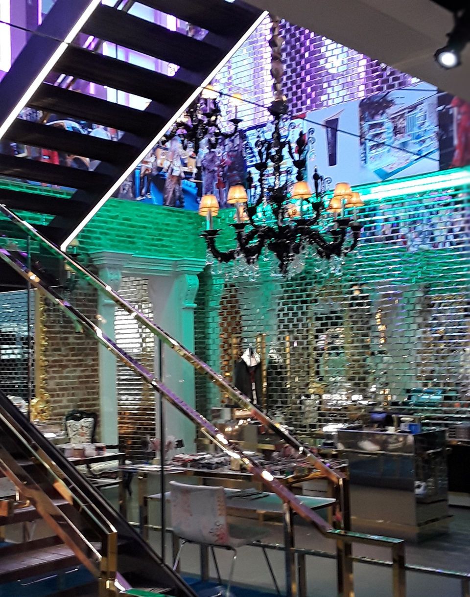 A staircase with a chandelier hanging from the ceiling