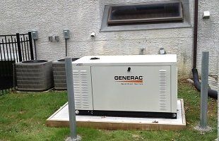 A generac generator is sitting in the backyard of a house.
