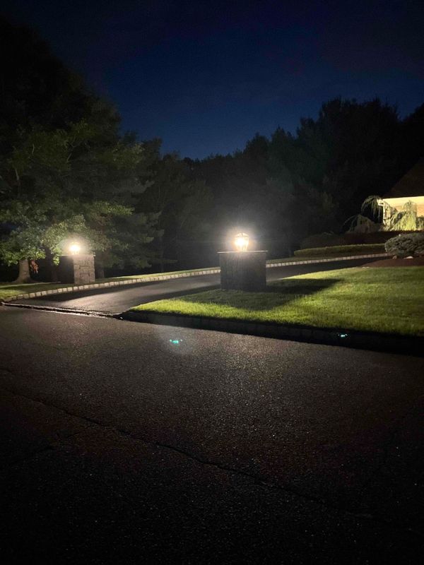 A driveway with a lot of lights on it at night.