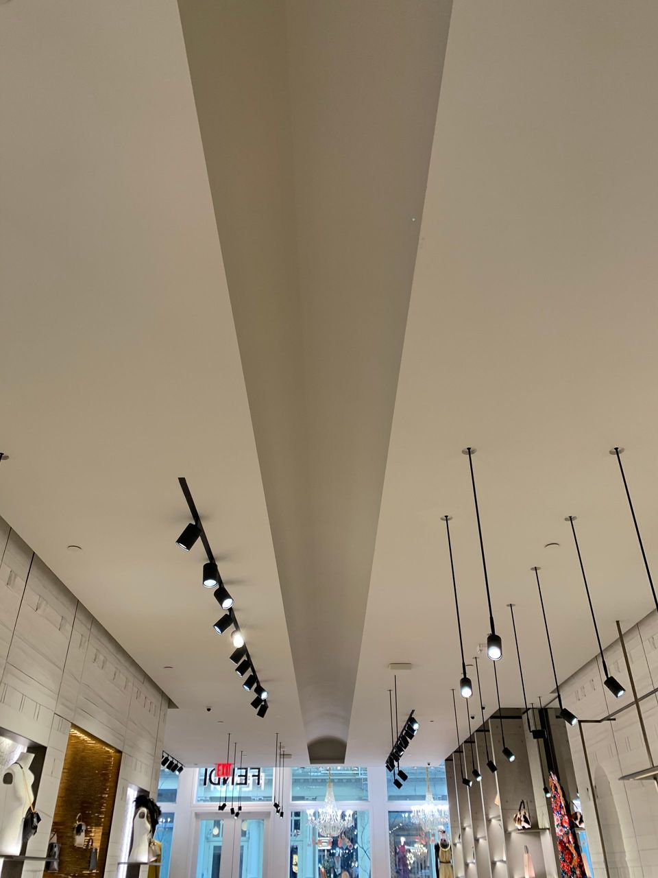 Looking up at the ceiling of a store with lights hanging from it