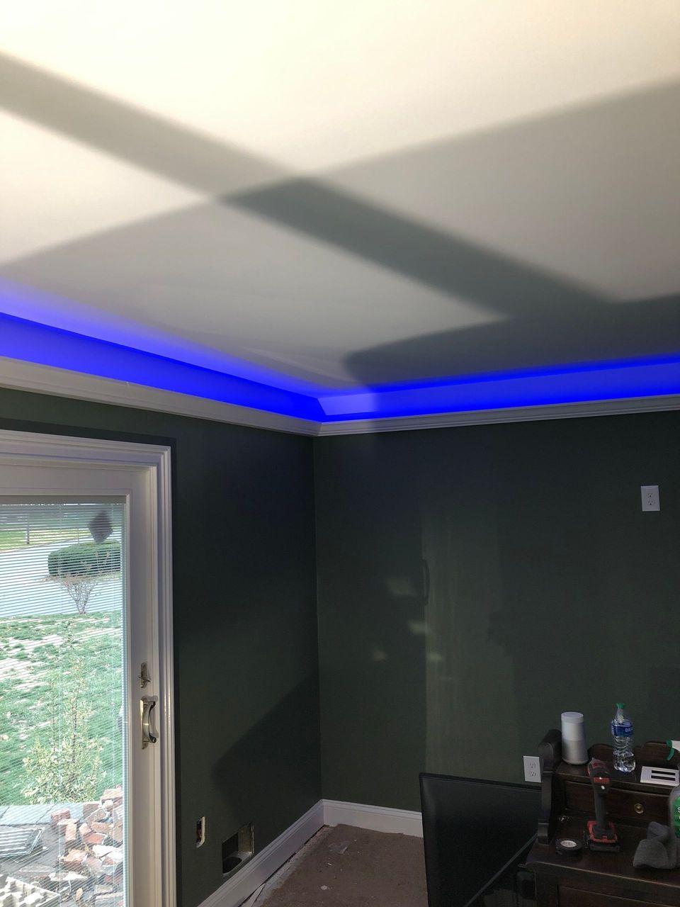 A living room with a blue light on the ceiling