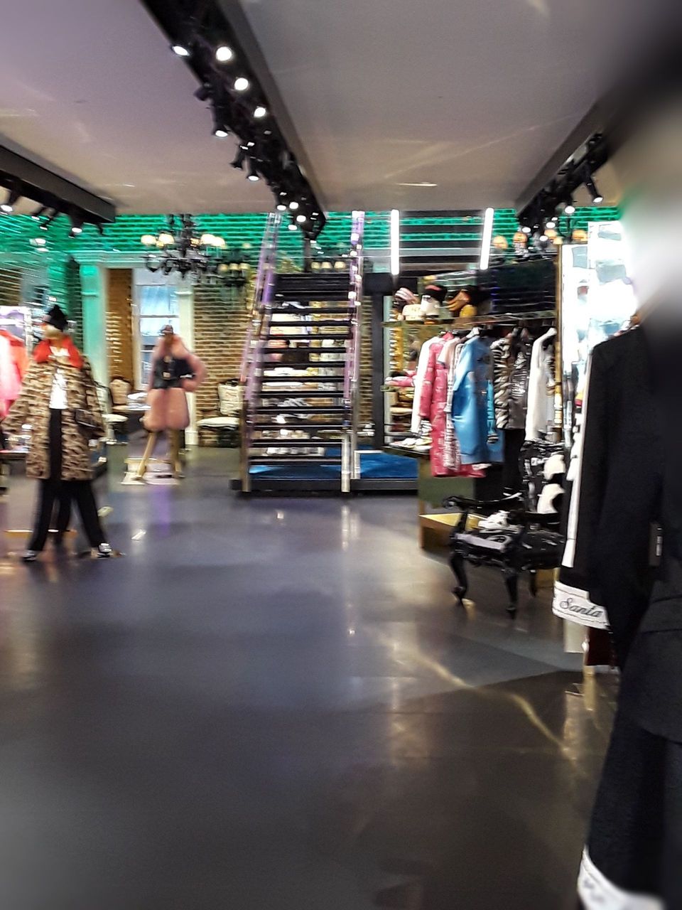 A blurry picture of a clothing store with people walking around