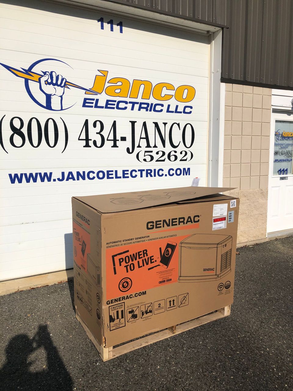 A box is sitting in front of a building that says janco electric llc