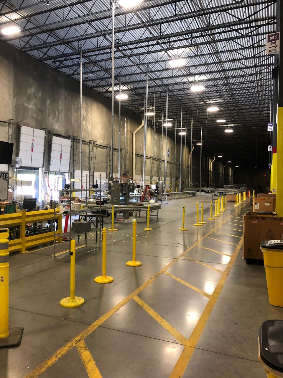A large warehouse with yellow lines on the floor