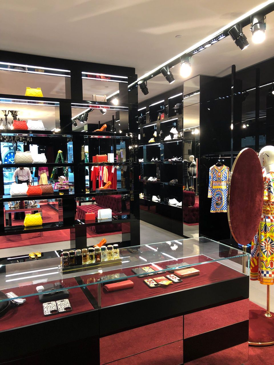 A store with a lot of shelves and a mannequin